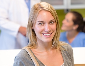 Smiling dental patient in reception area