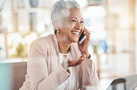 Smiling, mature woman speaking on phone