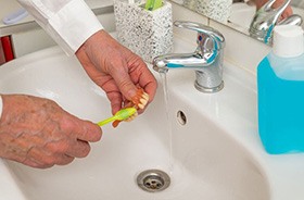 Senior person brushing their denture