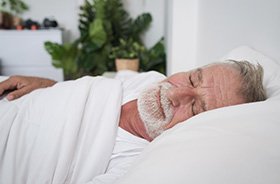 Older man sleeping at home