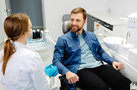 Happy patient talking to his dentist