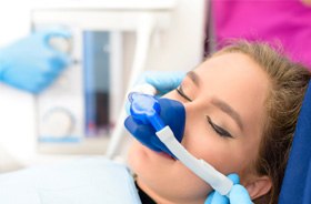 Woman relaxing while wearing nasal mask for nitrous oxide