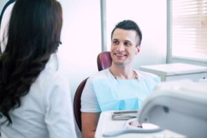 Dentist and patient having friendly conversation